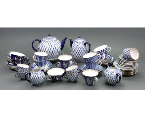A Lomonosov Russian porcelain 23-piece tea and coffee service, late 20th century, painted with a trellis pattern in blue and 