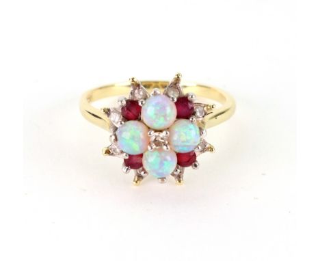 A yellow gold, diamond, opal and ruby cluster ring, the star shaped cluster centred by a small round brilliant diamond and fo