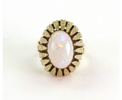 A gold and cabochon white opal cocktail ring, circa 1970, the oval opal within a stylised palm-leaf raised setting, stamped 1