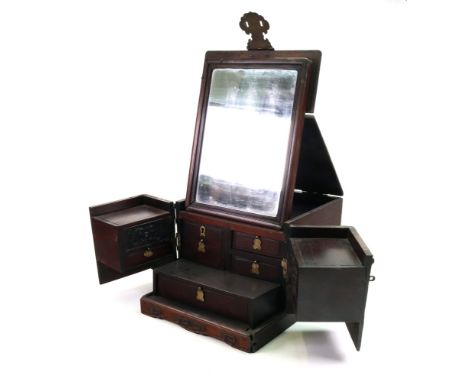 A Chinese rosewood brass mounted dressing cabinet, late 19th/early 20th century, the hinged top enclosing an easel mirror, th