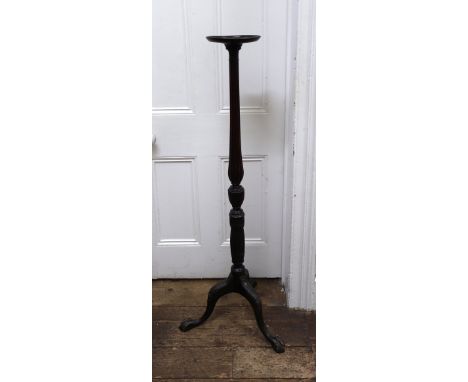 A George III style carved mahogany torchere, early 20th century, the dished circular top on a reeded, turned and fluted pilla