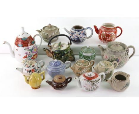 A group of fourteen Japanese and Chinese teapots and eleven covers, various dates, including a Chinese Imari teapot and a min