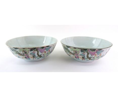 A pair of Chinese famille-rose bowls, late 19th/early 20th century, each painted on the exterior with a procession beneath a 