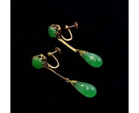 A pair of cabochon jade pendant earrings, the claw-set circular cabochons suspending a single pear-shaped drop, unmarked yell