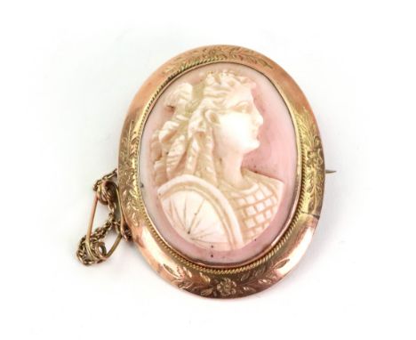 A gold and coral oval cameo brooch, depicting a portrait of a female warrior, the engraved frame stamped 9ct, 37mm x 30mm ove