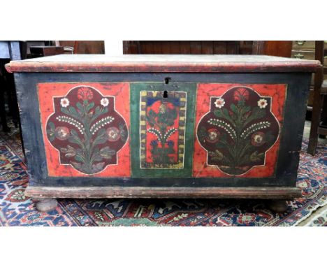 A pine coffer, possibly Tyrolean, first half 19th century, polychrome painted, with hinged top, the front with three floral p