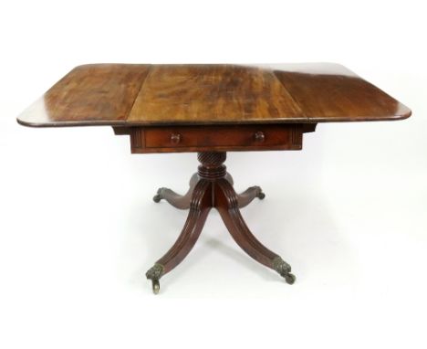 A Regency mahogany ebony banded breakfast table, with hinged drop leaves, two end drawers, on a ropetwist pillar and moulded 