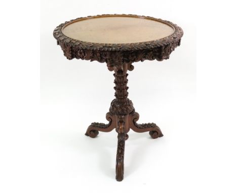 A Victorian oak revolving centre table, circa 1870, carved with a border of oak leaves and acorns to the dished circular top 