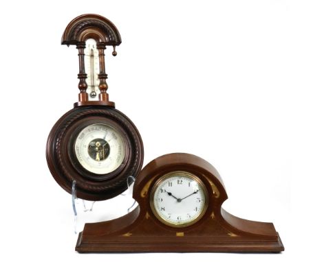 A French Art Nouveau mahogany walnut inlaid and mother of pearl mantel timepiece, of shaped outline, the white enamel dial wi