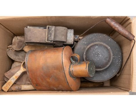 A WWI Trench lantern, a pioneer saw in its leather pouch; a pair of possibly WWI marching boots; a WWI entenching tool; a 190