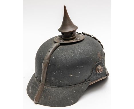 A WWI Bavarian pickelhaube, with brass mounts, leather liner, and traces of maker's stamp inside the skull and owner's name. 