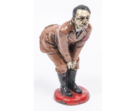 An unusual pin cushion caricature model of Adolf Hitler, bending over, made of metal, painted and with a fabric seat set in h