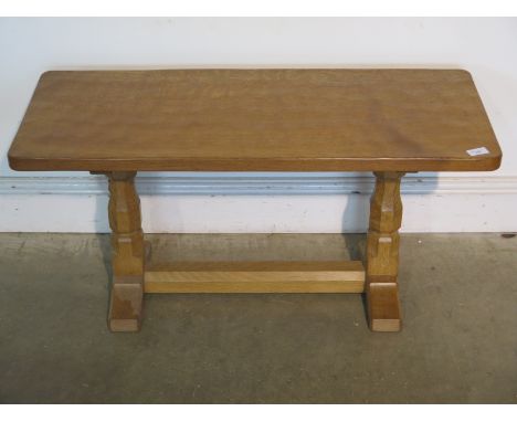 A Robert Thompson  of Kilburn "Mouseman" oak refectory coffee table with adzed top - 44cm tall x 92cm x 37cm - on octagonal  