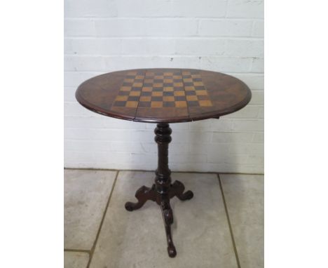 A 19th Century walnut games table with a drop leaf swivel action chess board top above two small drawers on a tripod base - 6