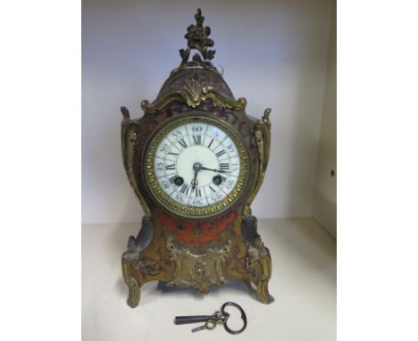 An Ormolu mounted French Boulle mantle clock - white enamel dial with roman numerals - approx 31cm in height - movement strik