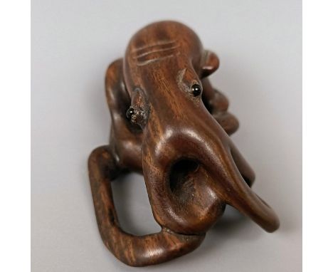 A carved wooden netsuke, in the form of an octopus, 5 cm wide and a carved wooden netsuke, in the form of mother and child, s