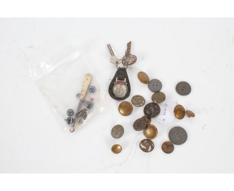 Collection of old buttons, to include one for Essex Constabulary, another with a stags head, together with a button hook, two