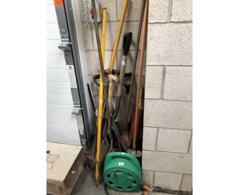 A quantity of garden tools including hose pipe.