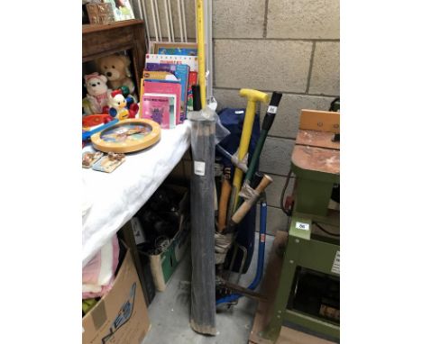 A quantity of garden tools and a set of drain rods.