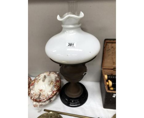 A Victorian oil lamp with shade.