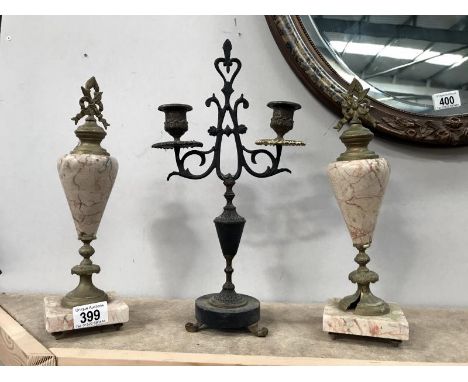 A pair of clock garnitures and a 19th century candlestick.