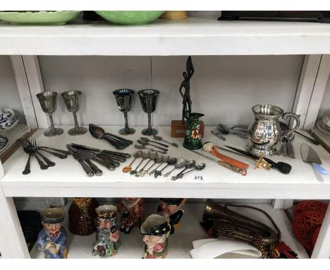 A shelf of silver plate, cutlery, letter openers etc.,