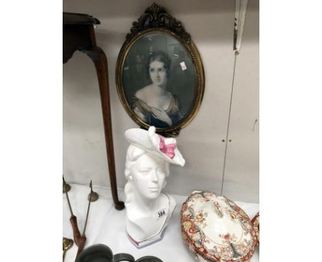 A ceramic bust of a lady and an oval framed portrait print.