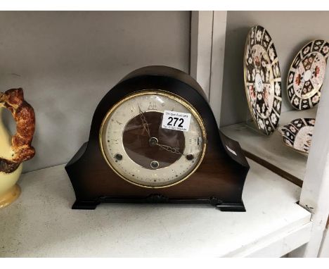 A wood cased mantel clock.