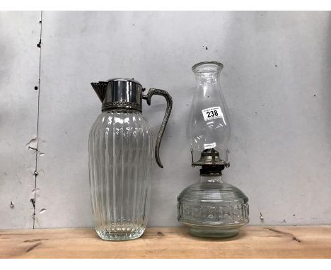 An oil lamp and a glass ewer.
