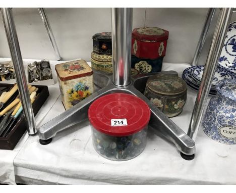 A quantity of vintage tins and a box of marbles.