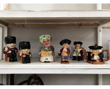 A shelf of Toby and character jugs including Shorter.