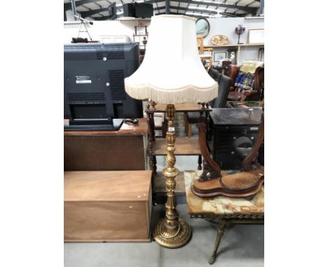 A gilded standard lamp with shade.