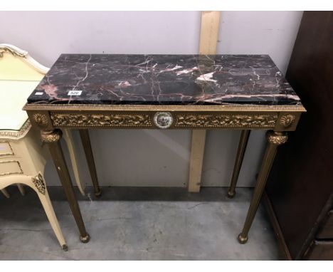 A gilded marble topped console table.