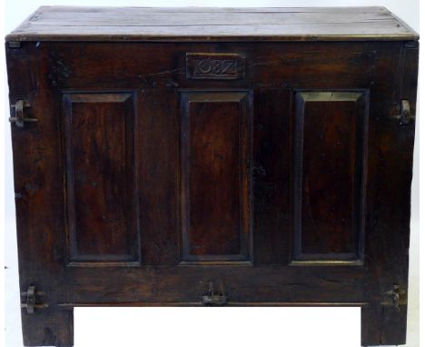 A 17th Century oak grain bin, dated 1682
The hinged lid enclosing storage space, above the carved date panel and three fielde