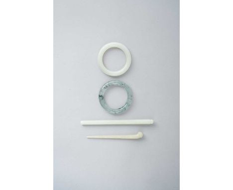 FOUR CHINESE JADE ITEMSQING DYNASTY OR LATERComprising: a white jade bangle; a white jade brush carved in low relief; and a p