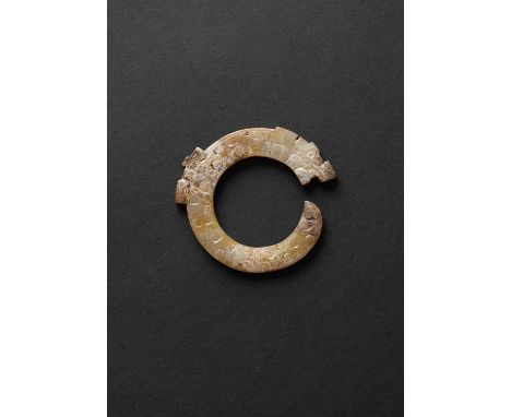 A CHINESE JADE 'DRAGON' PENDANTWARRING STATES PERIOD OR LATEROf circular form, carved as a dragon decorated all over with low