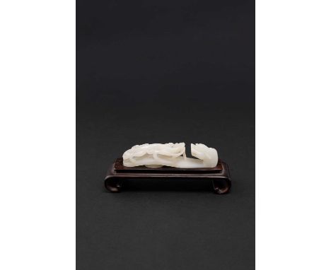 A CHINESE WHITE JADE BELTHOOKQIANLONG/JIAQINGDecorated in high relief with a sinuous chilong clambering on the shaft with a l