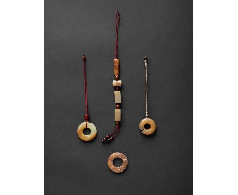FOUR CHINESE ARCHAISTIC CELADON AND RUSSET JADE CARVINGSQING DYNASTYComprising: a Hongshan-style pig-dragon pendant; a circul
