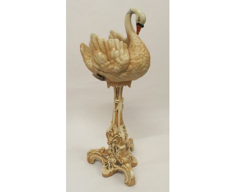 A ceramic jardinière in the form of a swan with scrolled floral decorated base, 97cm high Condition Report:Available upon req