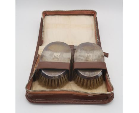 A leather cased silver mounted brush set, with two brushes and a comb, by S. Blanckensee &amp; Son Ltd, Chester 1936, togethe