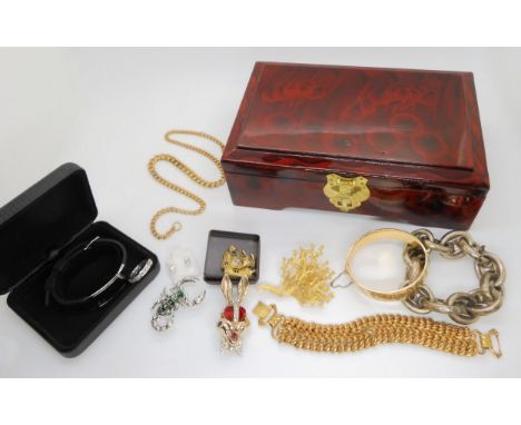 A gold plated wide bangle, a Bugs Bunny brooch by Karu, Fifth Avenue, and other items Condition Report:Not available for this