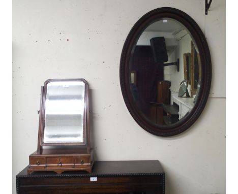 A Victorian mahogany three drawer toilet mirror and an oval bevelled glass wall mirror (2) Condition Report:Available upon re