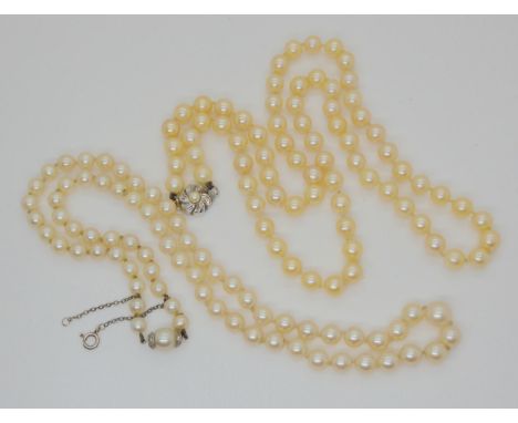 A string of good quality light cream cultured pearls with a pearl and diamond screw clasp, largest pearl 9mm, length 55cm, to