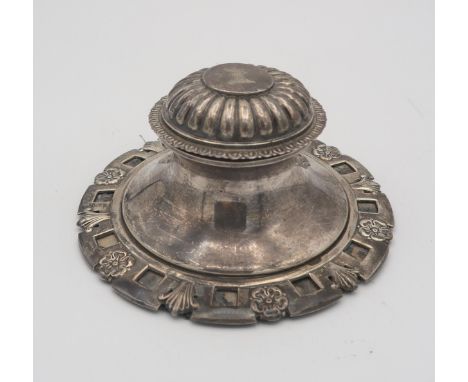 An Edwardian large silver capstan inkwell, the base decorated with cinquefoils and leaves, the lobed and engraved crested lid