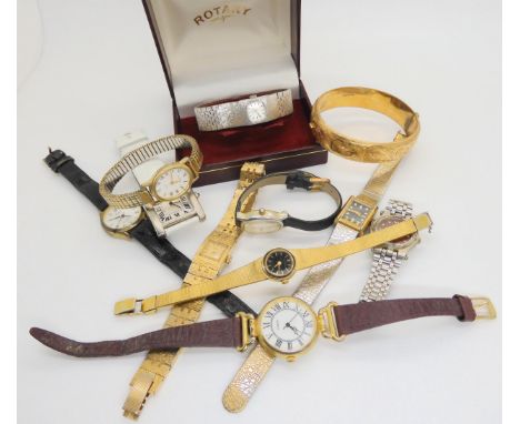 A gold plated wide engraved bangle, and a collection of retro and fashion watches to include Rotary etc Condition Report:Not 