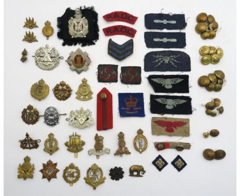 A collection of military cap badges and buttons, to include the Cameron Highlanders, King's Own Scottish Borderers, Royal Sco