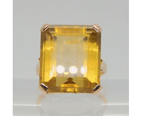 A yellow metal ring set with a large step cut citrine, dimensions 16.7mm x 14.5mm x 8.9mm, size L1/2, weight 6.6gms Condition