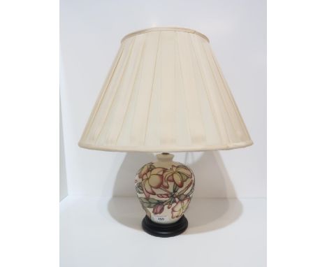 A Moorcroft table lamp with pink flowers on a cream background Condition Report:Available upon request