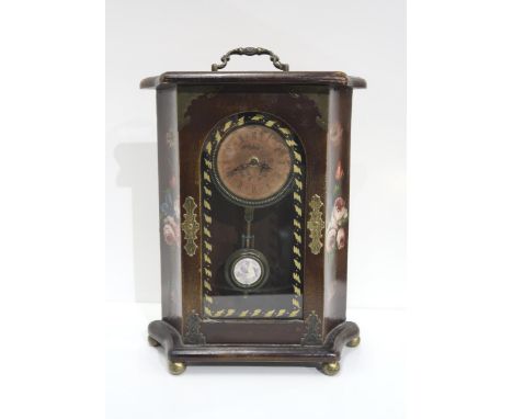A battery powered wooden hand-painted mantle clock, painted with floral sprays, the front with brass mounts, on four brass bu