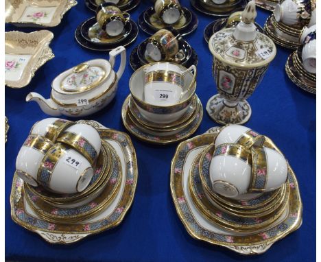 A Rosslyn China teaset, the white ground with a border of pink roses, scale decoration and dragons within a gilt edge togethe